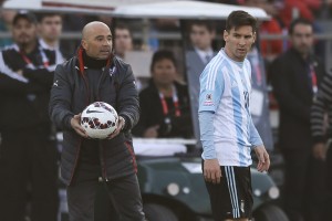 Argentina's Lionel Messi, right, walks past Chile's coach Jorge Sampaoli, left, during the Copa America final soccer match at the National Stadium in Santiago, Chile, Saturday, July 4, 2015. (AP Photo/Ricardo Mazalan)